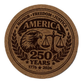Round cork coaster with an eagle, scales of justice, and 'America 250 Years' text on a white background